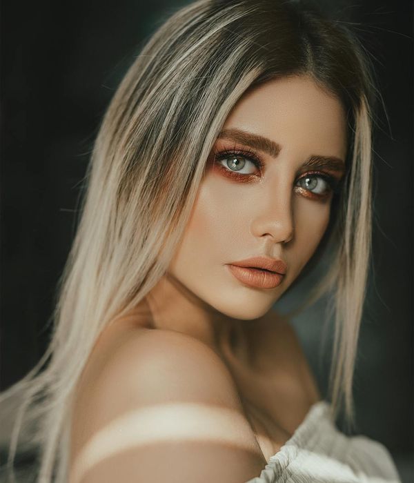 Woman with a calm and focused expression looking forward.